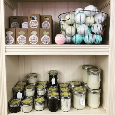 Shelves at Uniquely Wyoming with boxed soaps, bath bombs and jars of bath salts